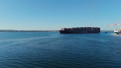 Ocean Freight Ship Departs Halifax With Tugboat Escort Aerial View