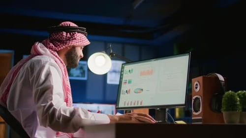 Man Analyzing Financial Data at Computer Workstation