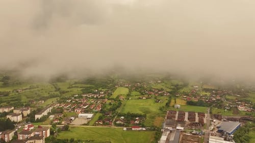 Explore a captivating drone view of a bustling cityscape under a summer rain, with glistening street