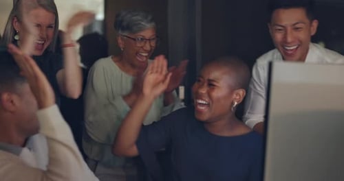 Diverse Group Celebrates a Win in the Office
