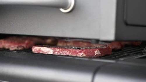 Fresh Raw Beef Meat Steaks on grill, Slow motion