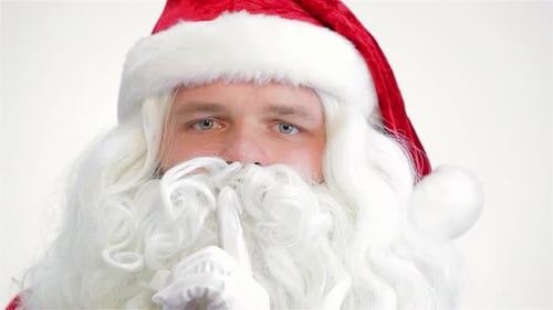 Festive Santa Claus Gesturing for Silence Close Up