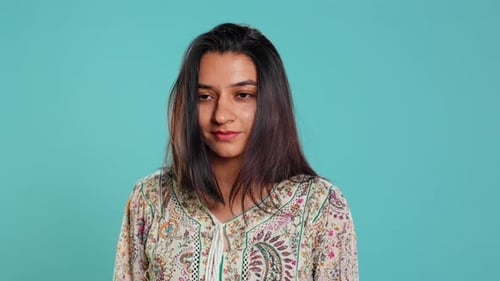 Portrait of Smiling Young Adult Woman with Arms Crossed