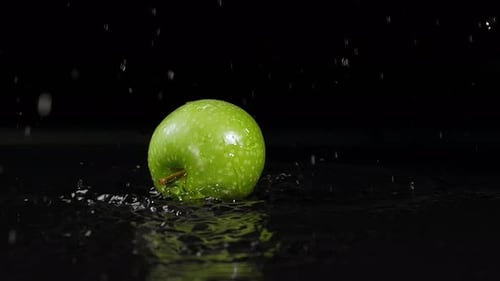 Apple Falling Into Water Slow Motion Black Background 4k