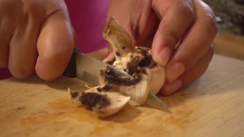 Slicing a Mushroom on a Cutting Board