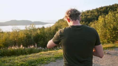 Person Enjoying Rural Landscape at Golden Hour