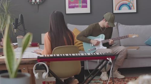 Two Young Adults Creating Music at Home