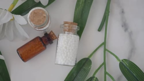 Homeopathic Treatments with Pills, Flowers, and Jars