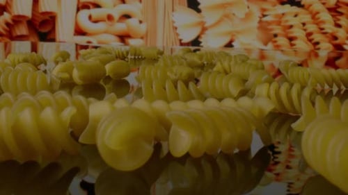 view close up of uncooked rotini pasta with camera moving forward.