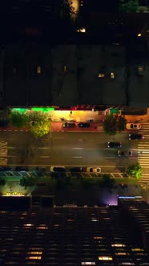 Beautifully lit streets of night New York. Lots of cars going along the roads and passing crossroads