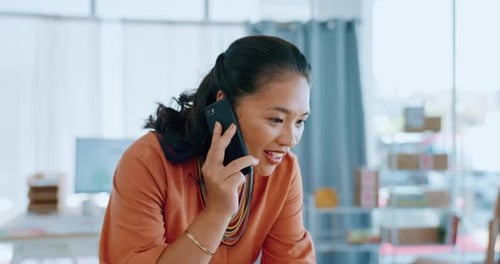 Woman Talking on Phone While Working on Laptop