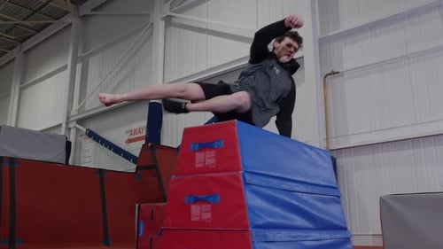 Agile Athlete Vaults Over Gym Obstacle Course