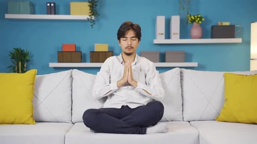Young Adult Meditating at Home for Stress Relief