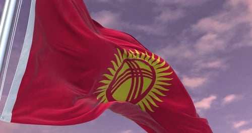 Waving Flag of Kyrgyzstan Against a Cloudy Sky