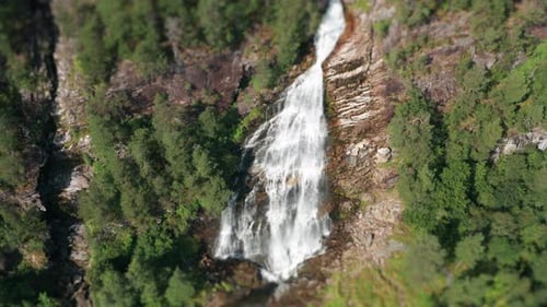 Aerial View of Waterfall Through Lush Green Trees