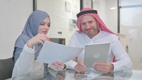 Business Professionals Reviewing Documents in Office