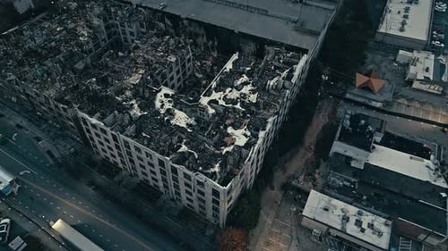 Burned down housing area in american city. Homeless population after fire. Aerial orbit top down.
