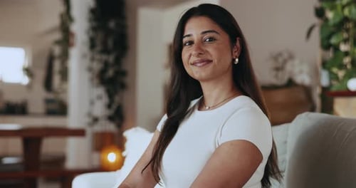Smiling Woman Sitting on Couch in Bright Living Room