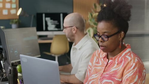 Diverse Coworkers Developing New Software in Open Space Office