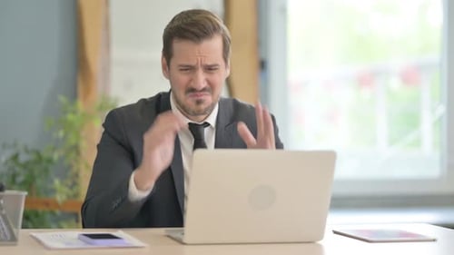 Man Frustrated with Computer at Office Desk