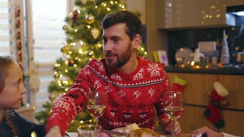 Family enjoys Christmas dinner together in decorated home