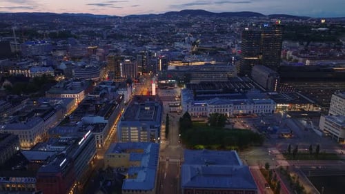 Slider of Streets and Building in City at Dusk Aerial View of Evening Cityscape Revealing Platforms