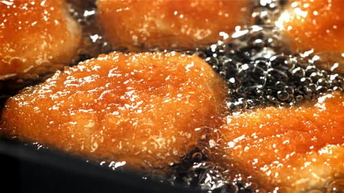 Chicken Nuggets are Fried in Oil Filmed on a Highspeed Camera at 1000 Fps