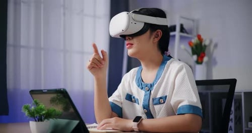 Woman Using VR Headset at Desk Indoors