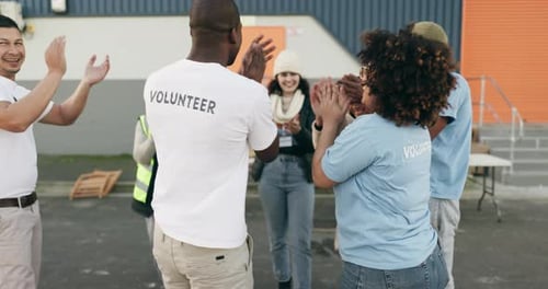 Volunteer, applause with team building and charity mission with energy and people are excited