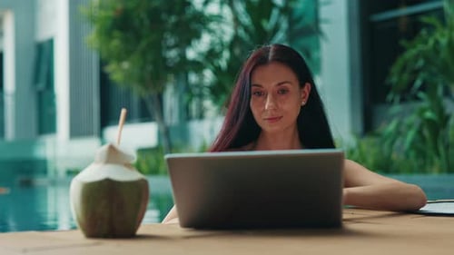 Woman Works By The Tropical Pool