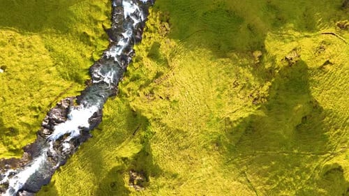 Aerial revealing shot of the cascade of waterfalls leading to the Seljalandsfoss waterfall