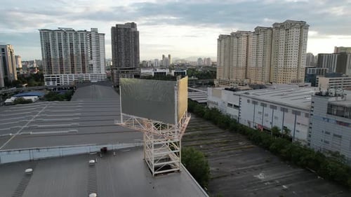 4K Aerial drone shot of an empty billboard in USJ Subang Jaya during sunrise lock track back left sh