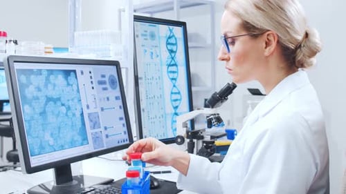Female Scientist Analyzing Test Tube in Lab Setting