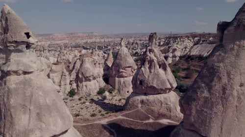 Close aerial view of Cappadocia's iconic fairy chimneys and rocky terrain