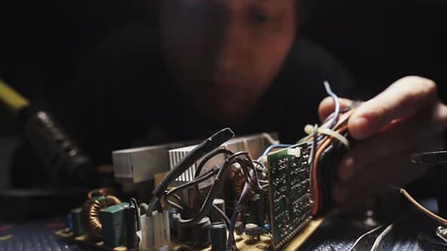 Technician Repairing Computer Electronic Circuit Board Close Up