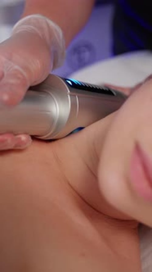 Medical Professional Treating Patient's Neck with Modern Device