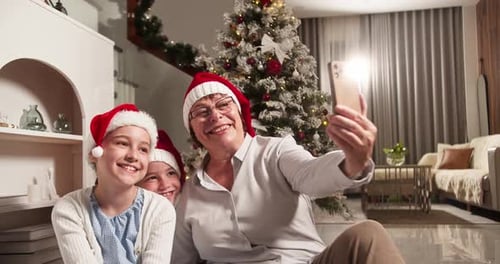 Grandmother and Grandchildren Take Christmas Selfie