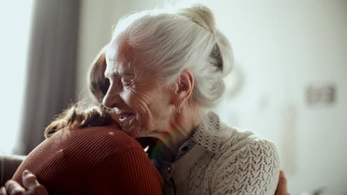 Emotional Hug Between Grandmother and Grandchild Indoors