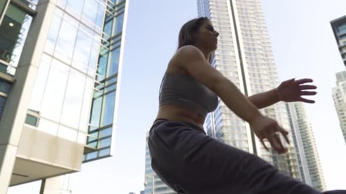 Woman Dancing Outdoors in Urban Cityscape