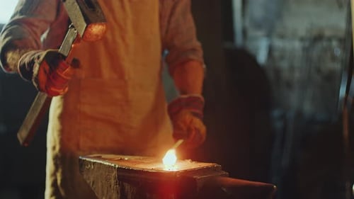 Blacksmith Doing Hot Metalwork on Anvil in the Workshop