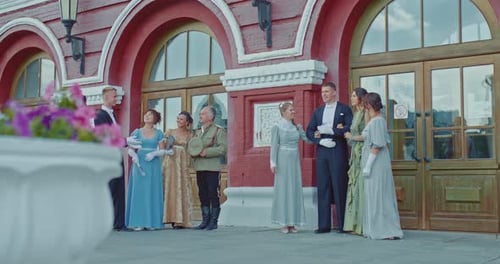 People in Formal Wear Outside Historic Building