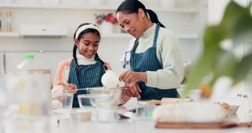 Woman and Child Baking Together in Kitchen