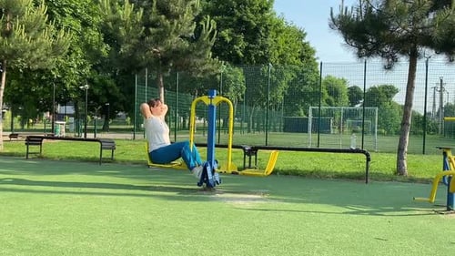 Young woman works out at the sport area outdoors