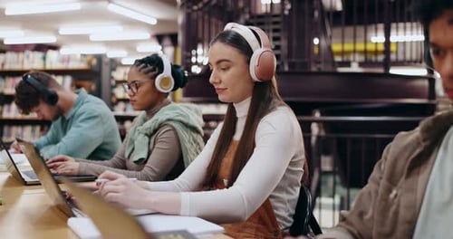 University, student and headphones with laptop in library for writing assignment essay