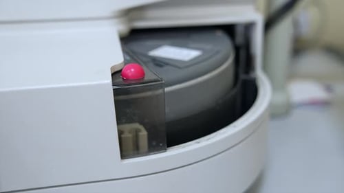 Few test tubes are moving in the apparatus. Advanced equipment in the technological science