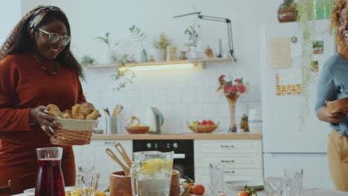 Two Women Preparing Food in Bright Kitchen