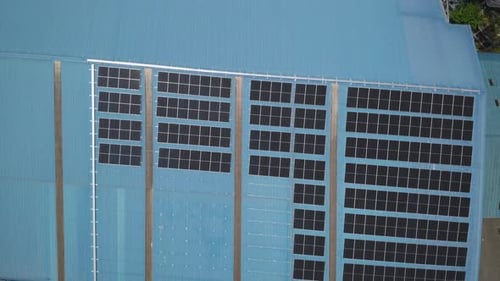 Aerial view of solar cell panels installed on roof of the factory