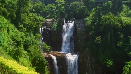 Majestic Waterfall Cascading Down Lush Green Hills in Sri Lanka