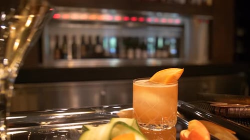 Cocktail on Bar with Cucumber and Orange Slice