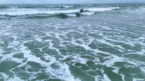 Closeup of Foamy Ocean Waves Moving on Water Surface Drone Video